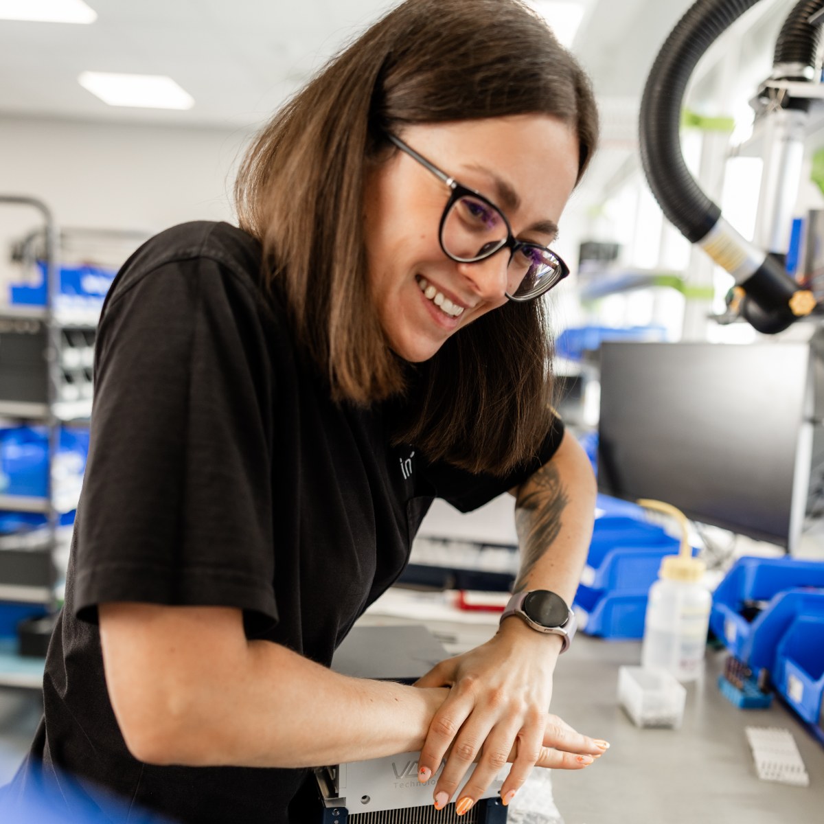 Inheco employee working on precise laboratory equipment